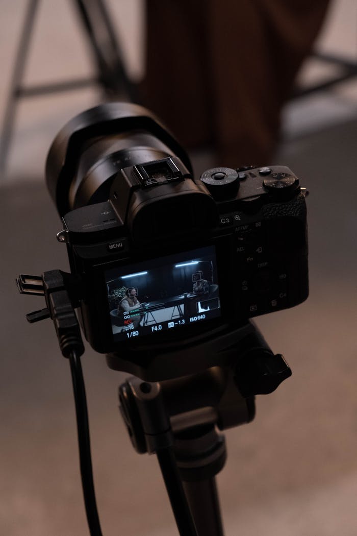 The Art of Drawing Readers In: Your attractive post title goes here Close-up of a camera mounted on a tripod focused on a video production scene.